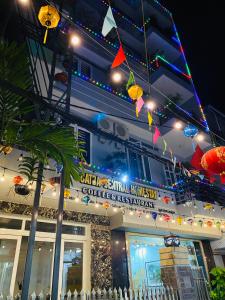 a building with lights in front of it at Cat Ba Central Homestay in Cat Ba