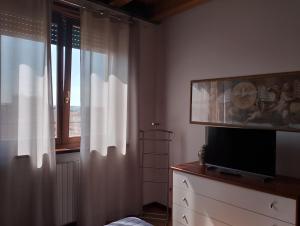 a living room with a tv and a window at La Casa di Mia in Verona