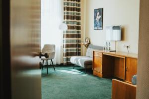 a bedroom with a bed and a desk and a chair at Polonia Raciborz in Racibórz