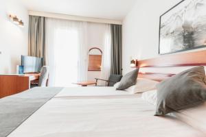 Posteľ alebo postele v izbe v ubytovaní Hotel Horizont