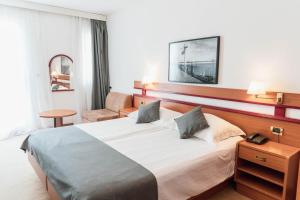 Posteľ alebo postele v izbe v ubytovaní Hotel Horizont