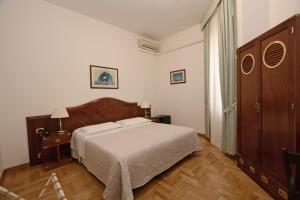 Postel nebo postele na pokoji v ubytování Albergo Italia
