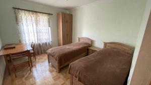 a room with two beds and a table and a desk at Green Paradise in Ijevan +46 photos