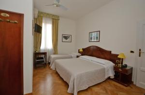 Postel nebo postele na pokoji v ubytování Albergo Italia