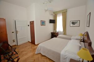 Postel nebo postele na pokoji v ubytování Albergo Italia