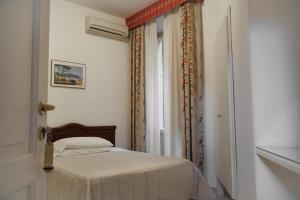 Postel nebo postele na pokoji v ubytování Albergo Italia