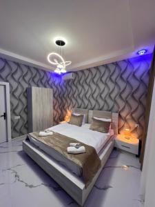 a bedroom with a large bed with purple lighting at Qafqaz Modern Luxryland in Gabala +53 photos