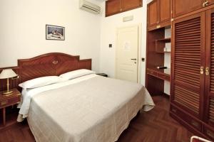 Postel nebo postele na pokoji v ubytování Albergo Italia