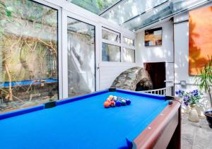 a pool table in a room with windows at 1 Bight Boatyard in Dartmouth