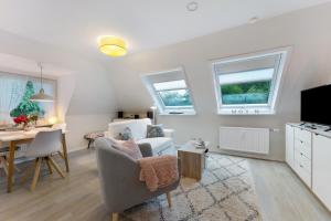 a living room with a chair and a table at Appartement Skagen in Glücksburg