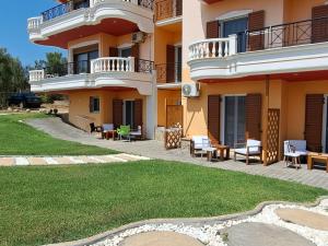 a large apartment building with a patio and lawn at Foinikounta view in Finikounta