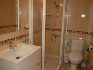 a bathroom with a shower and a toilet and a sink at Camins 2 in Riumar +12 photos