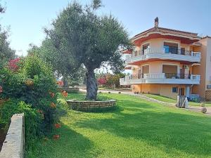 a large house with a tree in the yard at Foinikounta view in Finikounta