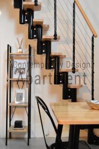 a black chandelier hanging over a wooden table at Contemporary Design Loft & Apartment Padova in Padova