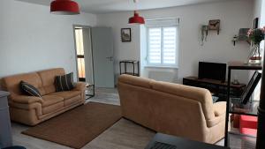 a living room with two chairs and a couch at Chez Annette in Merxheim