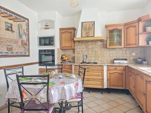 a kitchen with a table and chairs in it at MAISON FAMILIALE in Rueil-Malmaison +14 photos