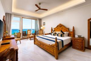 a bedroom with a bed and a desk and a room with a bed sidx sidx at Araliya Beach Resort & Spa Unawatuna- Where you meet the sea all year in Unawatuna