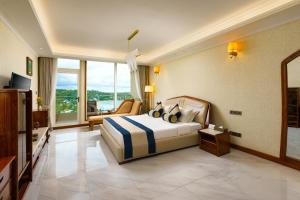 a hotel room with a bed and a large window at Araliya Beach Resort & Spa Unawatuna- Where you meet the sea all year in Unawatuna