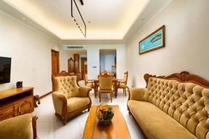 a living room with a couch and a table at Araliya Beach Resort & Spa Unawatuna- Where you meet the sea all year in Unawatuna