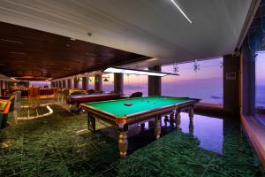 a pool table in a room with a view of the ocean at Araliya Beach Resort & Spa Unawatuna- Where you meet the sea all year in Unawatuna
