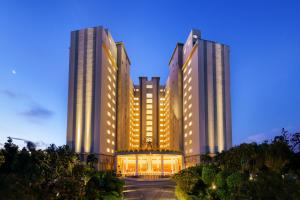 two tall buildings with lights in front of a building at Araliya Beach Resort & Spa Unawatuna- Where you meet the sea all year in Unawatuna
