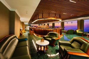 a hotel lobby with chairs and a bar at Araliya Beach Resort & Spa Unawatuna- Where you meet the sea all year in Unawatuna