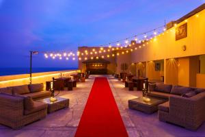 a red carpet in a room with couches and a red path at Araliya Beach Resort & Spa Unawatuna- Where you meet the sea all year in Unawatuna