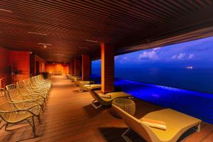 a room with chairs and a large window with the ocean at Araliya Beach Resort & Spa Unawatuna- Where you meet the sea all year in Unawatuna