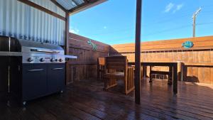a kitchen with a stove and a table on a deck at 3bd unit feilding in Feilding