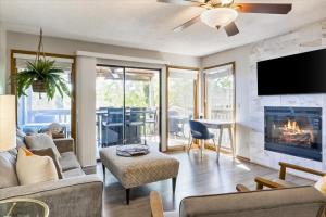 a living room with a fireplace and a tv at Full Moon Condo in Lake Ozark