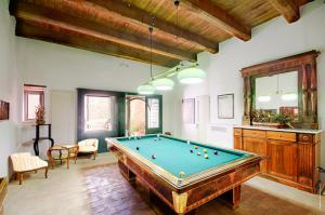 a large room with a pool table in it at Castello Di Postignano Relais in Sellano
