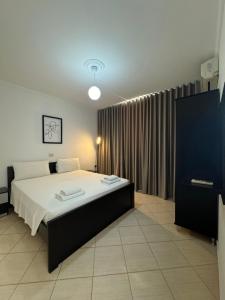 a bedroom with a large bed in a room at Villa White in Ksamil