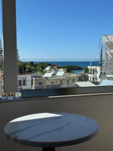 a table in front of a window with a view at Villa White in Ksamil