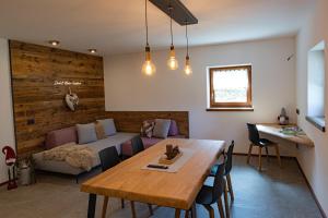a living room with a table and a couch at Chalet Aquila - Chalet Maso Vecchio fra le montagne del Trentino in Castello Tesino