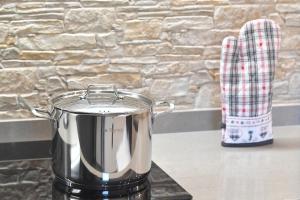 a pot sitting on top of a stove at Chalet Aquila - Chalet Maso Vecchio fra le montagne del Trentino in Castello Tesino