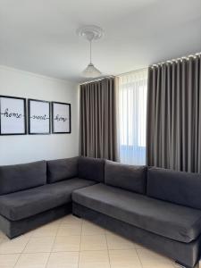 a living room with a large couch in front of a window at Villa White in Ksamil