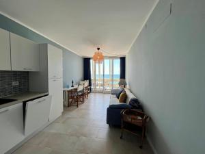 a living room with a couch and a table with chairs at Appartamento Zipser II in Grado