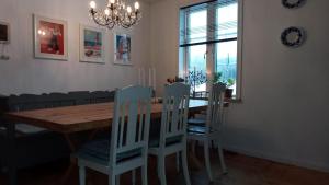 a dining room with a wooden table and chairs at Hollands Län in Unnaryd