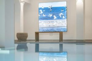 a living room with a picture of birds on the wall at Strandburg 207 in Juist