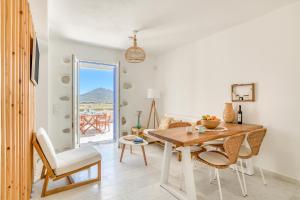 a living room with a wooden table and chairs at Paros Sea View Eco - Aetherian Ciel Villas, Alia in Mármara