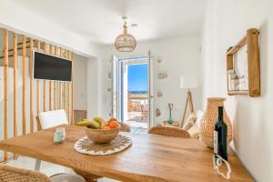 a dining room with a table with a bowl of fruit at Paros Sea View Eco - Aetherian Ciel Villas, Alia in Mármara
