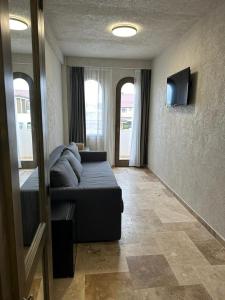 a living room with a couch and a television at Selora Vama Veche in Vama Veche