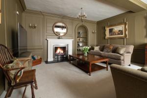a living room with a fireplace and a couch at St Martin's House in Chichester
