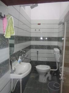 a small bathroom with a toilet and a sink at Feel Aesthetic Kashi Home Stay in Varanasi