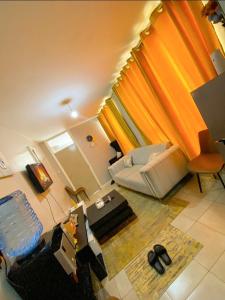 a living room with a couch and a table at Feel Home -One bedroom with swimming pool in Kiambu +23 photos