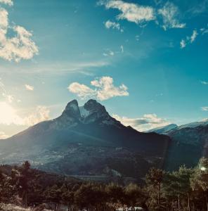 a mountain in the distance with a blue sky and clouds at Racons del Pedraforca in Saldés