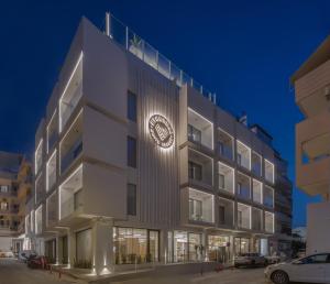 a building with a clock on the side of it at Ethereal White Resort Hotel & Spa in Heraklio