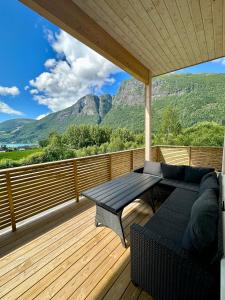 a patio with a couch and a table on a deck at Loen Panorama in Stryn