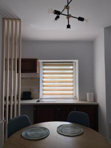a dining room with a table and a window at B residence - Apartment B in Iaşi
