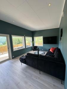 a living room with a couch and a table at Loen Panorama in Stryn